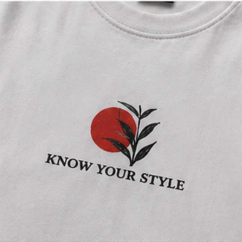 Close-up of the minimalist front chest graphic on the Sakura Oversized Graphic Tee.